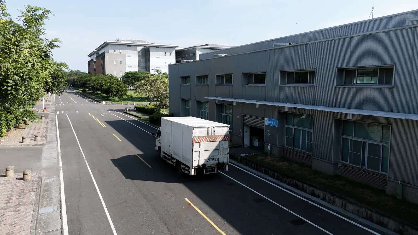 Road and trucks outside the factory